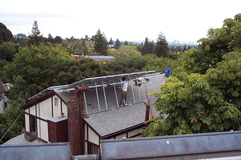Solar installers working on a rooftop photovoltaic array